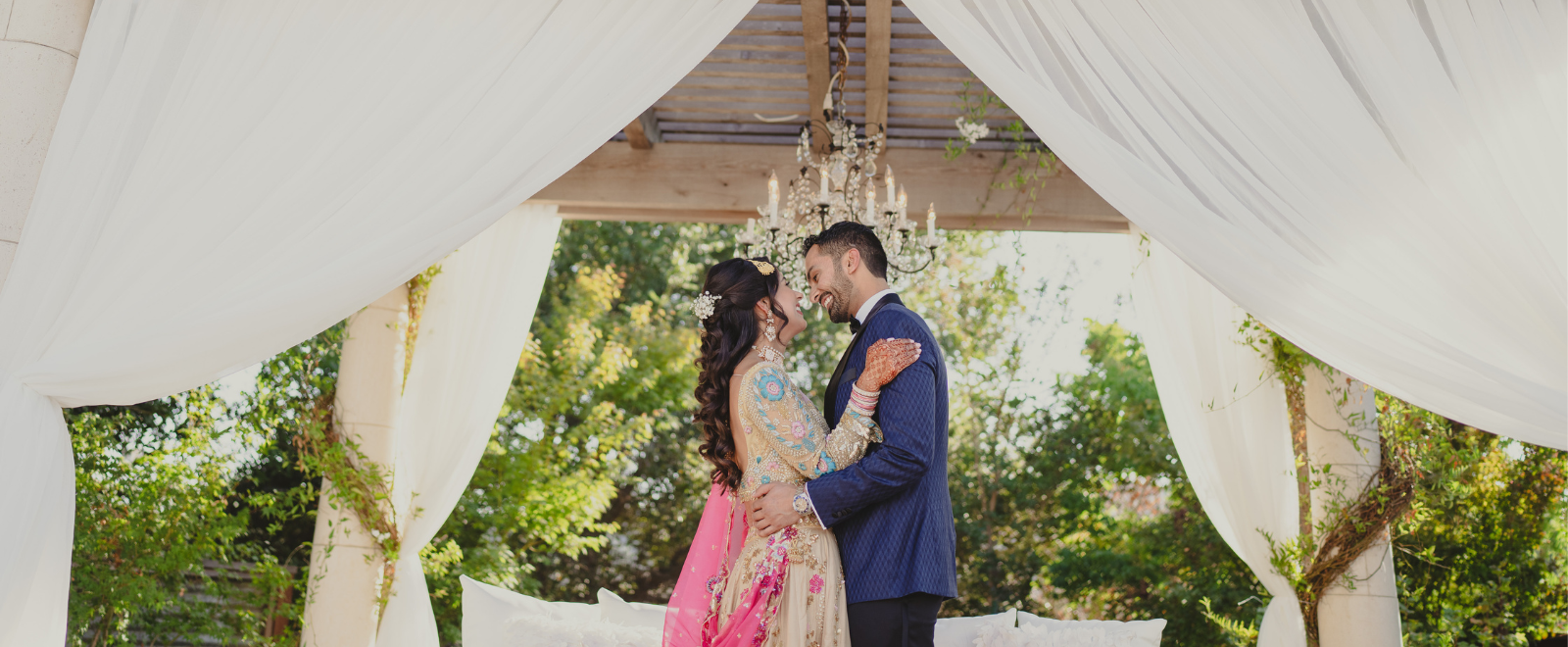 Indian engagement couple portrait under floral mandap – Amreet and Nirpaul engagement ceremony