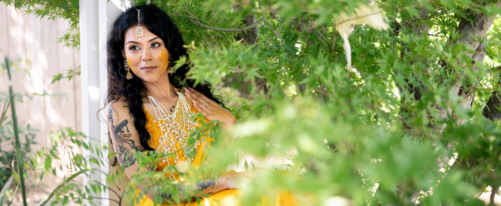 Anjelica posing during her vibrant Indian haldi ceremony in yellow bridal attire