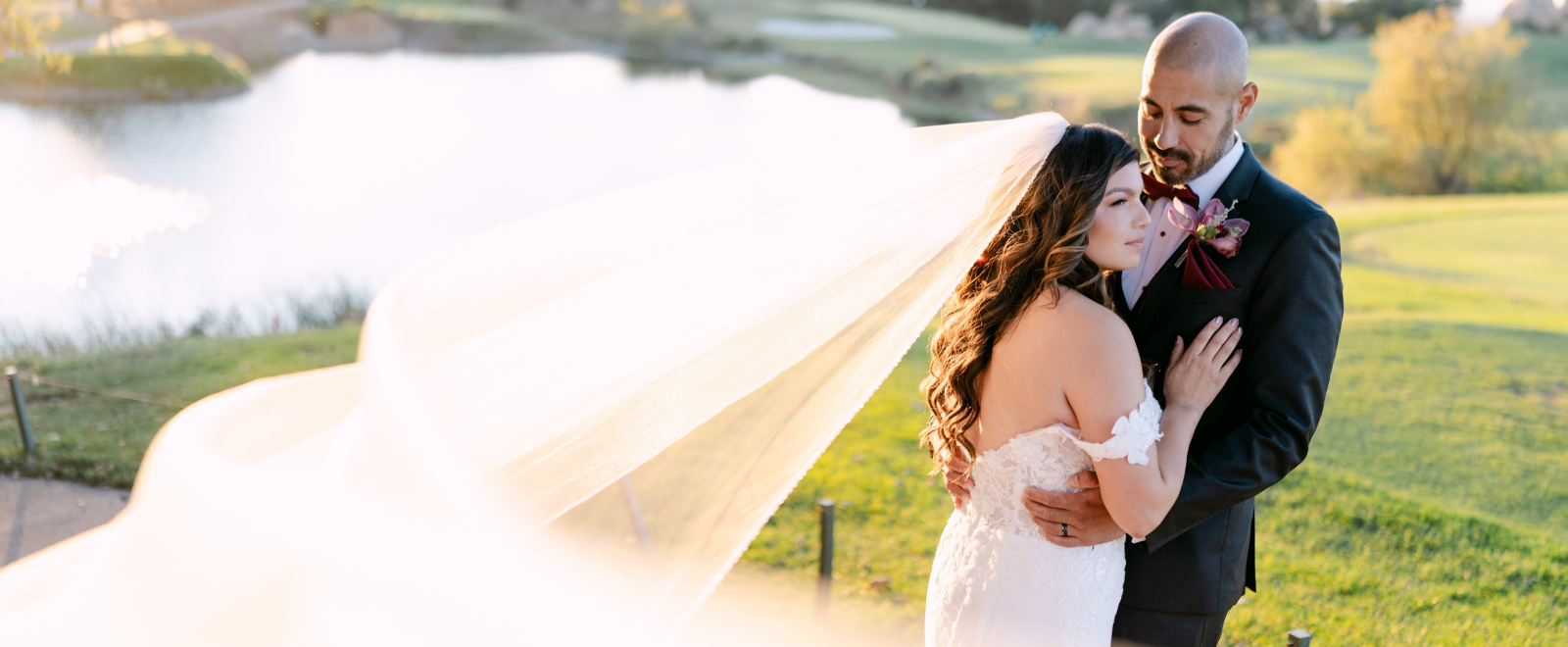 bride and groom under veil during golden hour at lakeside wedding boulder ridge wedgewood weddings