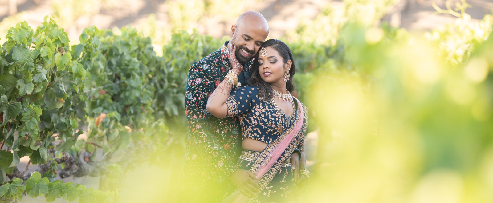Luxury South Asian wedding reception at Leal Vineyards with elegant wine barrel backdrop